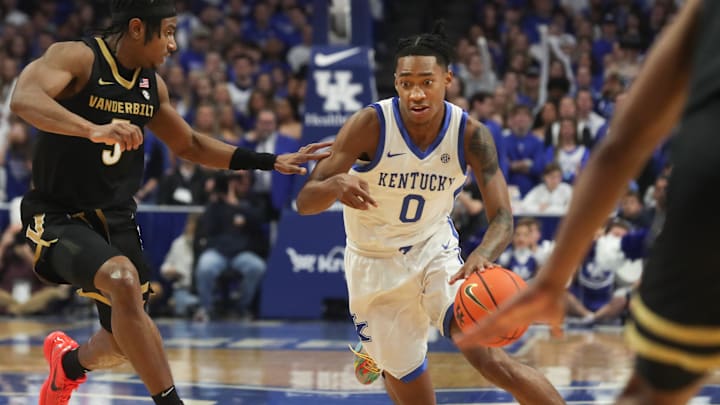 Kentucky's guard Rob Dillingham (0) drives past Vanderbilt's guard Ezra Manjon (5)