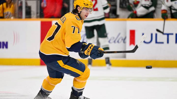 Feb 4, 2026; Nashville, Tennessee, USA;  Nashville Predators right wing Luke Evangelista (77) knocks the puck down against the Minnesota Wild during the third period at Bridgestone Arena. Mandatory Credit: Steve Roberts-Imagn Images