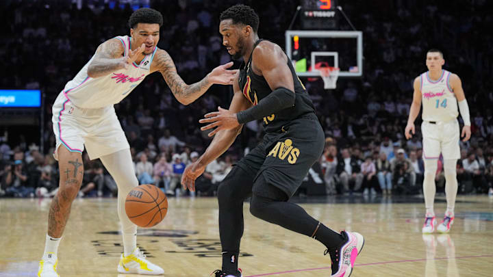 Jan 29, 2025; Miami, Florida, USA;  Cleveland Cavaliers guard Donovan Mitchell (45) steals the ball from Miami Heat center Kel'el Ware (7) during the second half at Kaseya Center. Mandatory Credit: Jim Rassol-Imagn Images