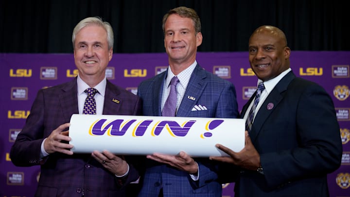 Dec 1, 2025; Baton Rouge, LA, USA; LSU president Wade Rousse, left, LSU new head coach Lane Kiffin and LSU athletic director Verge Ausberry stand together at South Stadium Club at Tiger Stadium. Mandatory Credit: Matthew Hinton-Imagn Images