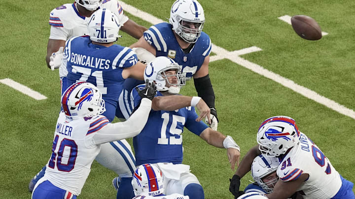 Nov 10, 2024; Indianapolis, Indiana, USA; Indianapolis Colts quarterback Joe Flacco (15) fires off a pass as Buffalo Bills defenders move in Sunday, Nov. 10, 2024, during a game against the Buffalo Bills at Lucas Oil Stadium in Indianapolis. Mandatory Credit: Grace Smith-USA TODAY Network via Imagn Images
