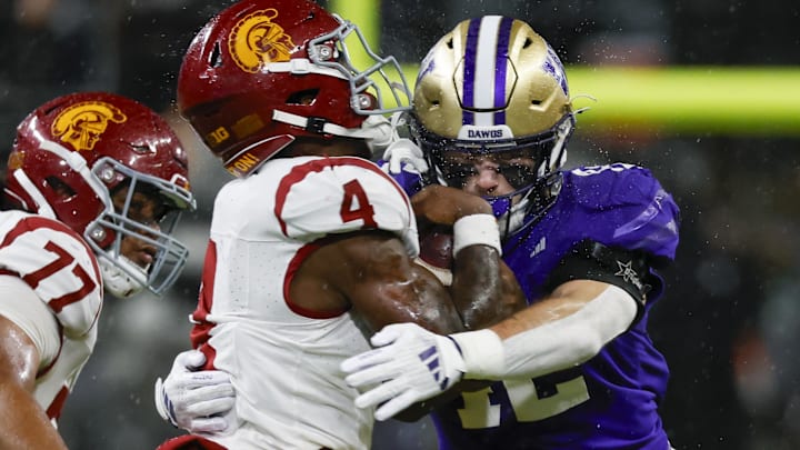 Huskies linebacker Carson Bruener brings down USC running back Woody Marks at Husky Stadium. Huskies linebacker Carson Bruener brings down USC running back Woody Marks at Husky Stadium.