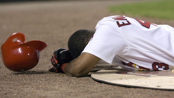 St. Louis Cardinals pinch hitter Juan Encarnacion (43) lies motionless after being hit in the face by a foul ball