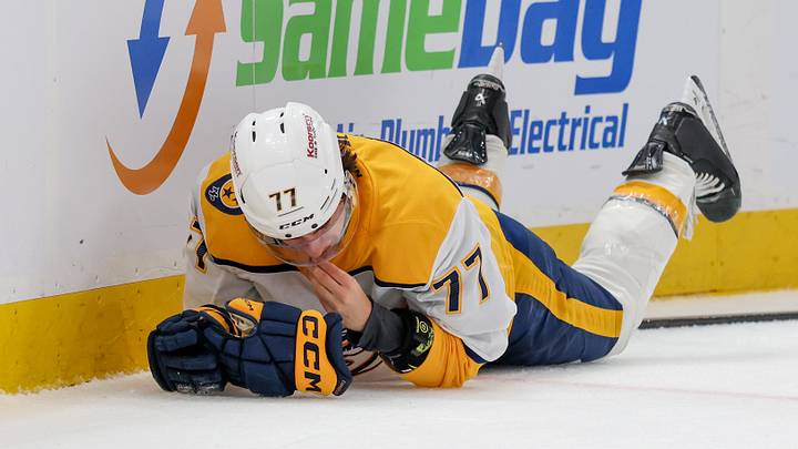 Apr 9, 2026; Salt Lake City, Utah, USA; Nashville Predators right wing Luke Evangelista (77) lies on the ice after a cross-check from Utah Mammoth defenseman Mikhail Sergachev (not pictured) during the third period at Delta Center. Mandatory Credit: Rob Gray-Imagn Images