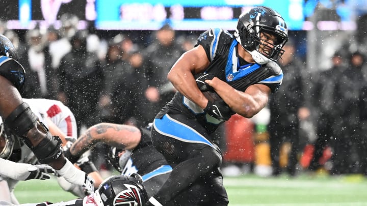 Dec 17, 2023; Charlotte, North Carolina, USA; Carolina Panthers running back Chuba Hubbard (30) runs as Atlanta Falcons safety DeMarcco Hellams (37) defends in the fourth quarter at Bank of America Stadium. Mandatory Credit: Bob Donnan-USA TODAY Sports