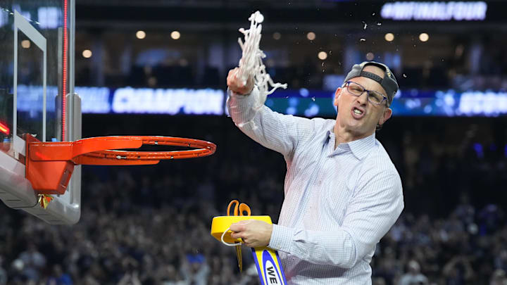 Huskies head coach Dan Hurley cuts down the net in 2023.