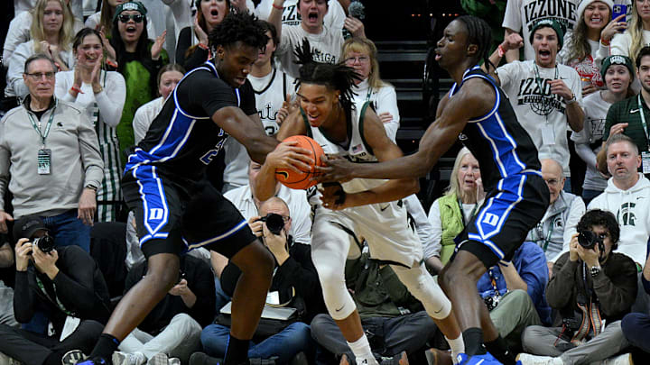 Dec 6, 2025; East Lansing, Michigan, USA;  Michigan State Spartans forward Jordan Scott (6) gets trapped by the Duke Blue Devils defense during the first half at Jack Breslin Student Events Center. Mandatory Credit: Dale Young-Imagn Images