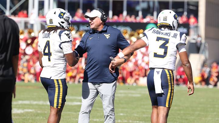 Oct 3, 2026; Ames, Iowa, USA; West Virginia Mountaineers head coach Rich Rodriguez celebrates with West Virginia Mountaineers quarterback Michael Hawkins Jr. (3) and West Virginia Mountaineers running back Cam Cook (4) after the touchdown against the Iowa State Cyclones during the second half at Jack Trice Stadium. Mandatory Credit: Reese Strickland-Imagn Images Oct 3, 2026; Ames, Iowa, USA; West Virginia Mountaineers head coach Rich Rodriguez celebrates with West Virginia Mountaineers quarterback Michael Hawkins Jr. (3) and West Virginia Mountaineers running back Cam Cook (4) after the touchdown against the Iowa State Cyclones during the second half at Jack Trice Stadium. Mandatory Credit: Reese Strickland-Imagn Images