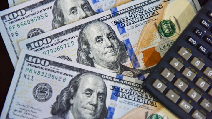 In this photo illustration, some 100 US dollar bills are...