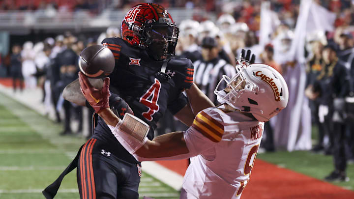 Nov 23, 2024; Salt Lake City, Utah, USA; Utah Utes cornerback Cameron Calhoun (4) and Iowa State Cyclones wide receiver Jayden Higgins (9) play for a ball during the third quarter at Rice-Eccles Stadium. Mandatory Credit: Rob Gray-Imagn Images