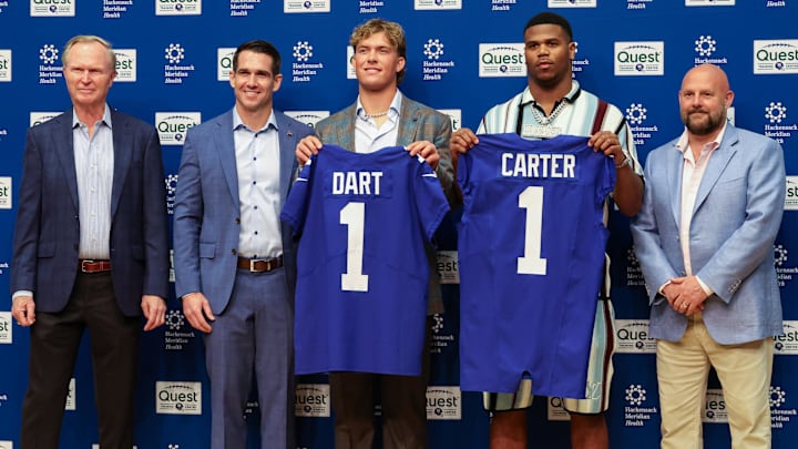 Apr 25, 2025; East Rutherford, NJ, US; New York Giants president John Mara (far left), general manager Joe Schoen (left), Jaxson Dart, Abdul Carter, and head coach Brian Daboll (right) pose for photos prior to the start of the press conference to introduce the Giants first round draft picks.  Mandatory Credit: Thomas Salus-Imagn Images