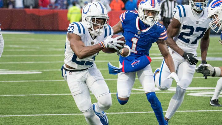 Nov 21, 2021; Orchard Park, New York, USA; Indianapolis Colts cornerback Kenny Moore II (23) returns an interception while being chased by Buffalo Bills wide receiver Emmanuel Sanders (1) in the third quarter at Highmark Stadium. Mandatory Credit: Mark Konezny-Imagn Images