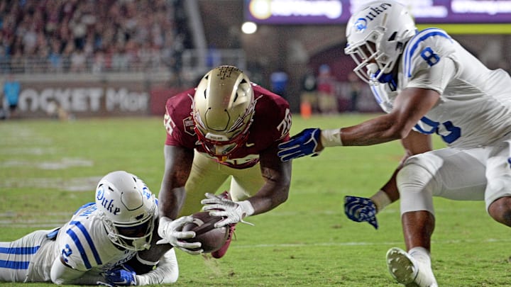 Oct 21, 2023; Tallahassee, Florida, USA; Florida State Seminoles running back Caziah Holmes (26) dives for a touchdown past Duke Blue Devils safety Jaylen Stinson (2) and linebacker Dorian Mausi (8) during the first half at Doak S. Campbell Stadium. Mandatory Credit: Melina Myers-Imagn Images