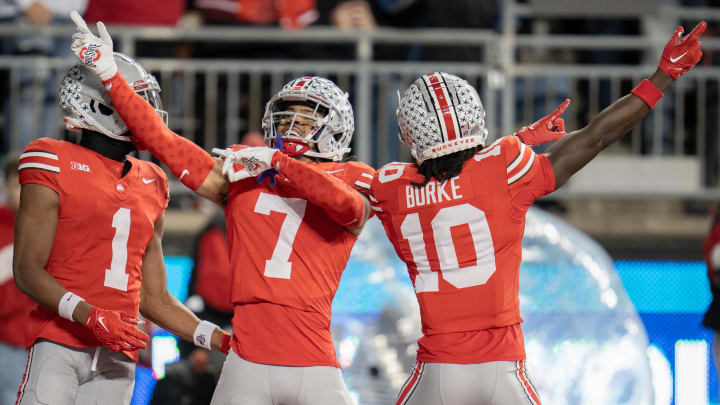 Nov 18, 2023; Columbus, Ohio, USA; 
Ohio State Buckeyes cornerback Jordan Hancock (7) celebrates an intercepted touchdown with Ohio State Buckeyes cornerback Denzel Burke (10) during the second half of their game on Saturday, Nov. 18, 2023 at Ohio Stadium.