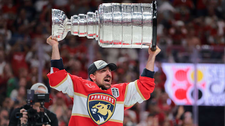 Jun 17, 2025; Sunrise, Florida, USA; Florida Panthers center Brad Marchand (63) hoists the Stanley Cup after winning game six of the 2025 Stanley Cup Final against the Edmonton Oilers at Amerant Bank Arena. Mandatory Credit: Sam Navarro-Imagn Images