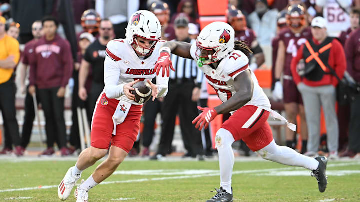 Nov 1, 2025; Blacksburg, Virginia, USA; Louisville Cardinals quarterback Miller Moss (7) hands the ball off to Louisville Cardinals running back Keyjuan Brown (22) during the fourth quarter at Lane Stadium. Mandatory Credit: Brian Bishop-Imagn Images Nov 1, 2025; Blacksburg, Virginia, USA; Louisville Cardinals quarterback Miller Moss (7) hands the ball off to Louisville Cardinals running back Keyjuan Brown (22) during the fourth quarter at Lane Stadium. Mandatory Credit: Brian Bishop-Imagn Images