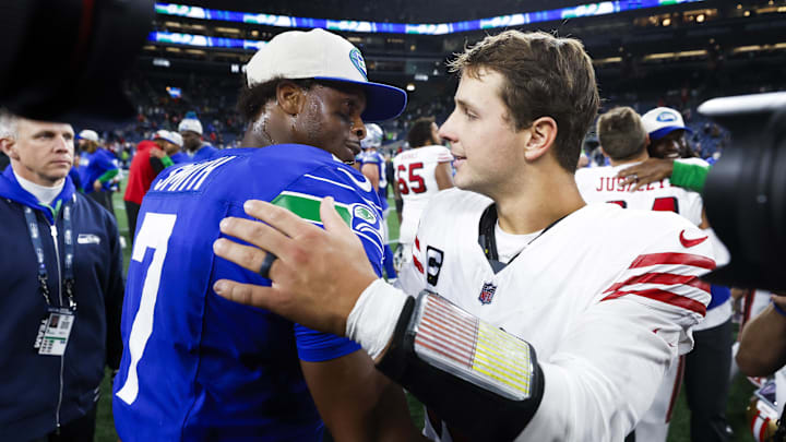 Oct 10, 2024; Seattle, Washington, USA; Seattle Seahawks quarterback Geno Smith (7) shakes hands with San Francisco 49ers quarterback Brock Purdy (13) following a 49er victory at Lumen Field. Mandatory Credit: Joe Nicholson-Imagn Images