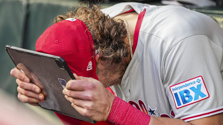 Apr 9, 2025; Cumberland, Georgia, USA; Philadelphia Phillies third base Alec Bohm (28) reacts in the dugout against the Atlanta Braves during the second inning at Truist Park. Mandatory Credit: Dale Zanine-Imagn Images