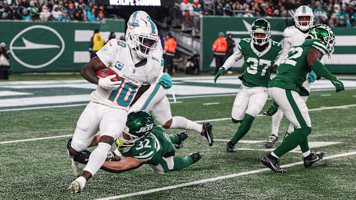 Miami Dolphins wide receiver Tyreek Hill (10) is tackled by New York Jets running back Isaiah Davis (32) during a punt return during the first half at MetLife Stadium in the 2024 season finale. Miami Dolphins wide receiver Tyreek Hill (10) is tackled by New York Jets running back Isaiah Davis (32) during a punt return during the first half at MetLife Stadium in the 2024 season finale.