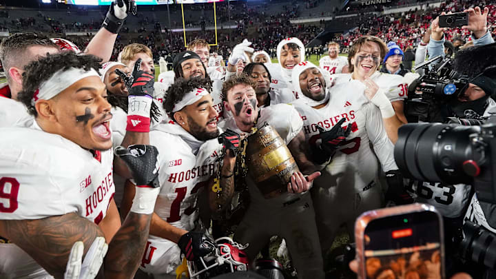 Indiana Hoosiers players celebrate with the Old Oaken Bucket on Saturday, Nov. 29, 2025, during the 100th annual Old Oaken Bucket game at Ross-Ade Stadium in West Lafayette. Indiana Hoosiers defeated the Purdue Boilermakers, 56-3. Indiana Hoosiers players celebrate with the Old Oaken Bucket on Saturday, Nov. 29, 2025, during the 100th annual Old Oaken Bucket game at Ross-Ade Stadium in West Lafayette. Indiana Hoosiers defeated the Purdue Boilermakers, 56-3.