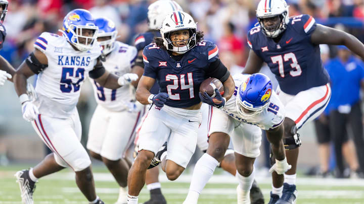 Nov 8, 2025; Tucson, Arizona, USA; Arizona Wildcats running back Quincy Craig (24) runs against the Kansas Jayhawks in the second half at Arizona Stadium. Mandatory Credit: Mark J. Rebilas-Imagn Images