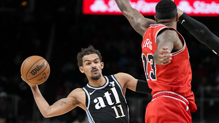  Atlanta Hawks guard Trae Young (11) paasses past Chicago Bulls forward Torrey Craig (13) during the first half at State Farm Arena. Mandatory Credit: Dale Zanine-Imagn Images
