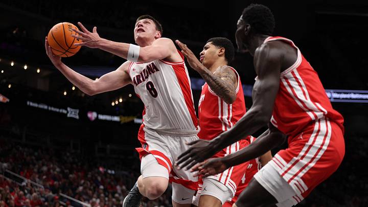 Mar 14, 2026; Kansas City, MO, USA; Arizona Wildcats forward Ivan Kharchenkov (8) drives to the hoop past Houston Cougars forward Chase McCarty (24) during the first half during the men's Big 12 Conference Tournament Championship at T-Mobile Center.