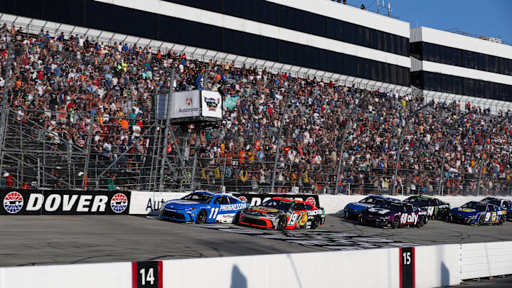 Jul 20, 2025; Dover, Delaware, USA; NASCAR Cup Series driver Denny Hamlin (11) leads the field on the final restart during the Autotrader EchoPark Automotive 400 at Dover Motor Speedway.