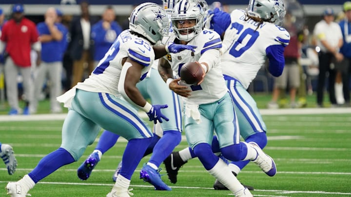 Dallas Cowboys quarterback Dak Prescott hands the ball off to running back Javonte Williams. Dallas Cowboys quarterback Dak Prescott hands the ball off to running back Javonte Williams.
