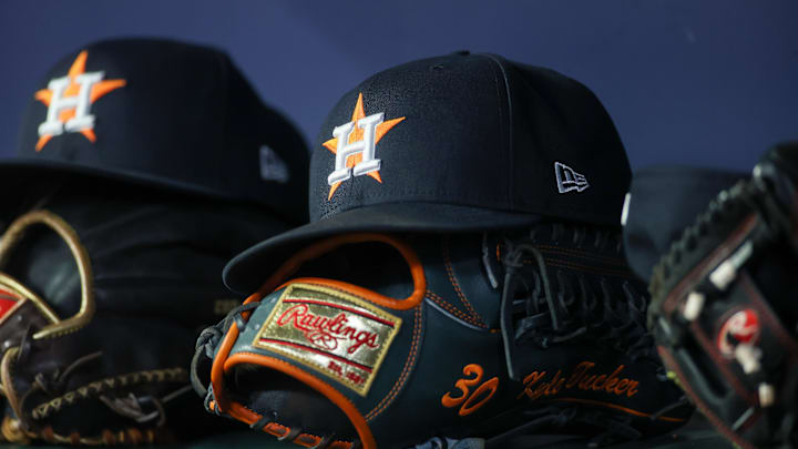 Apr 21, 2023; Atlanta, Georgia, USA; A detailed view of a Houston Astros hat and glove in the dugout against the Atlanta Braves in the fifth inning at Truist Park. Mandatory Credit: Brett Davis-Imagn Images