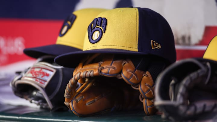 Aug 4, 2025; Atlanta, Georgia, USA; A detailed view of a Milwaukee Brewers hat and glove in the dugout against the Atlanta Braves in the fourth inning at Truist Park. Mandatory Credit: Brett Davis-Imagn Images