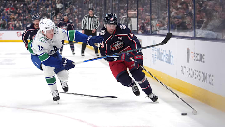 Blue Jackets forward Adam Fantilli tries to beat Canucks defenseman Elias Pettersson. Blue Jackets forward Adam Fantilli tries to beat Canucks defenseman Elias Pettersson.