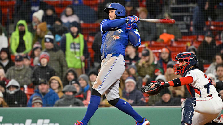 Apr 8, 2025; Boston, Massachusetts, USA; Toronto Blue Jays right fielder George Springer (4) hits a single against the Boston Red Sox during the seventh inning at Fenway Park.