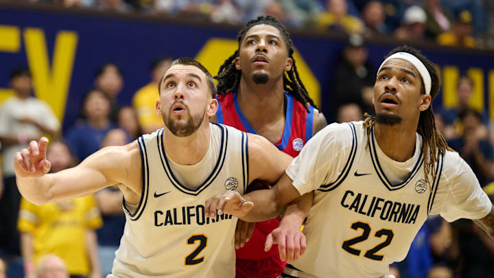John Camden, left, and Chris Bell block out an SMU player while awaiting a rebound.