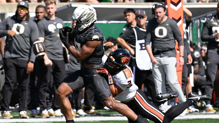Sep 20, 2025; Eugene, Oregon, USA; Oregon State Beavers linebacker Aiden Sullivan (2) forces a fumble by Oregon Ducks tight end Kenyon Sadiq (18) during the third quarter of the game at Autzen Stadium. Mandatory Credit: Troy Wayrynen-Imagn Images
