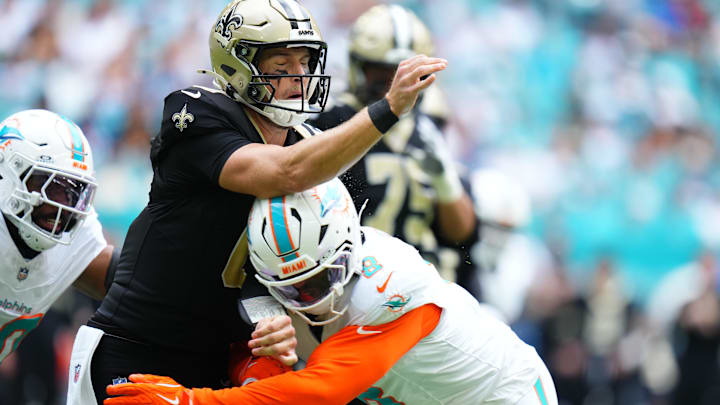 Miami Dolphins linebacker Matthew Judon (8) puts a hit on New Orleans Saints quarterback Tyler Shough (6) a during the first half at Hard Rock Stadium.