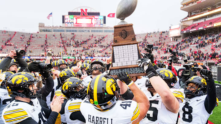 Nov 28, 2025; Lincoln, Nebraska, USA; The Iowa Hawkeyes hoist the Heroes Trophy after defeating the Nebraska Cornhuskers at Memorial Stadium. Mandatory Credit: Dylan Widger-Imagn Images