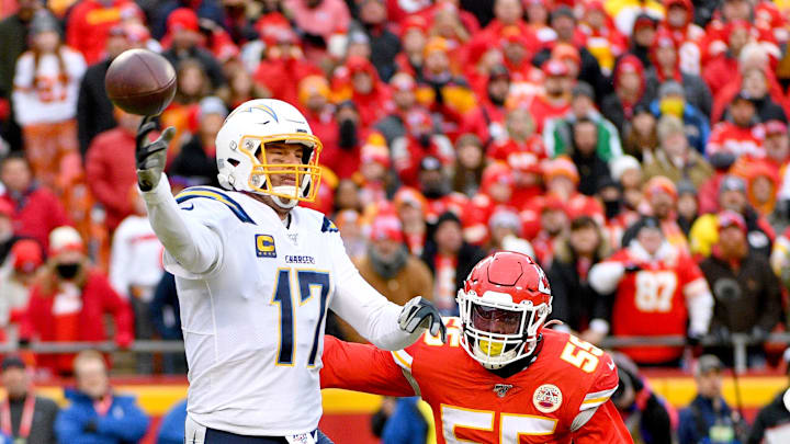 Dec 29, 2019; Kansas City, Missouri, USA; Los Angeles Chargers quarterback Philip Rivers (17) throws a pass as Kansas City Chiefs defensive end Frank Clark (55) defends during the second half at Arrowhead Stadium. Mandatory Credit: Denny Medley-Imagn Images