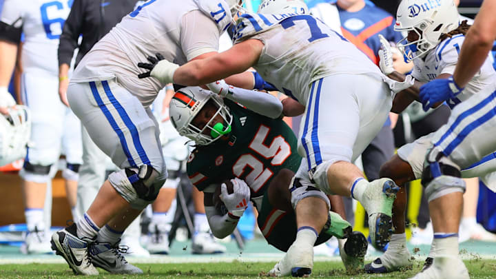 Nov 2, 2024; Miami Gardens, Florida, USA; Miami Hurricanes defensive back Jadais Richard (25) goes down after intercepting the football against the Duke Blue Devils during the fourth quarter at Hard Rock Stadium. Mandatory Credit: Sam Navarro-Imagn Images