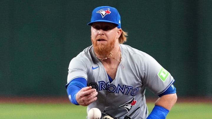 Jul 12, 2024; Phoenix, Arizona, USA; Toronto Blue Jays first base Justin Turner (2) flips the ball against the Arizona Diamondbacks during the first inning at Chase Field. Jul 12, 2024; Phoenix, Arizona, USA; Toronto Blue Jays first base Justin Turner (2) flips the ball against the Arizona Diamondbacks during the first inning at Chase Field.