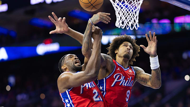 Apr 12, 2024; Philadelphia, Pennsylvania, USA; Philadelphia 76ers center Joel Embiid (21) and guard Kelly Oubre Jr. (9) grab a rebound against the Orlando Magic during the first quarter at Wells Fargo Center. Mandatory Credit: Bill Streicher-Imagn Images Apr 12, 2024; Philadelphia, Pennsylvania, USA; Philadelphia 76ers center Joel Embiid (21) and guard Kelly Oubre Jr. (9) grab a rebound against the Orlando Magic during the first quarter at Wells Fargo Center. Mandatory Credit: Bill Streicher-Imagn Images