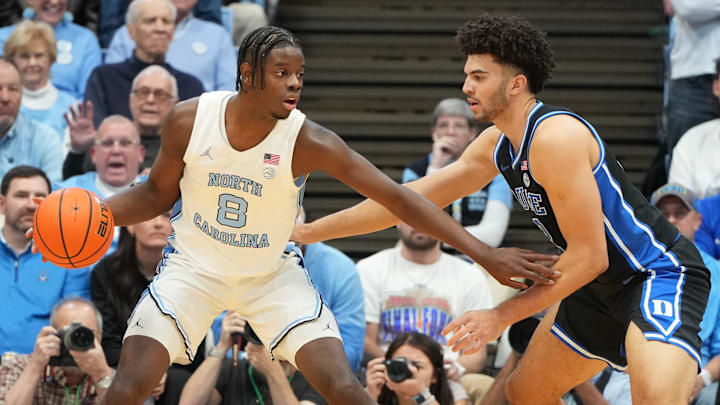 Feb 7, 2026; Chapel Hill, North Carolina, USA; North Carolina Tar Heels forward Caleb Wilson (8) with the ball as Duke Blue Devils forward Cameron Boozer (12) defends in the first  half at Dean E. Smith Center. Mandatory Credit: Bob Donnan-Imagn Images