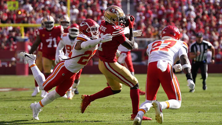 Oct 20, 2024; Santa Clara, California, USA; San Francisco 49ers wide receiver Brandon Aiyuk (11) catches a pass between Kansas City Chiefs cornerback Trent McDuffie (22) and safety Chamarri Conner (27) in the second quarter at Levi's Stadium. Mandatory Credit: Cary Edmondson-Imagn Images