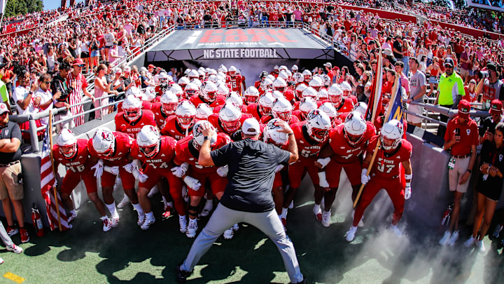 Oct 4, 2025; Raleigh, North Carolina, USA;  NC State Wolfpack head coach Dave Doeren with his team prepare to run out prior to the first half of the game against Campbell Fighting Camels at Carter-Finley Stadium. Mandatory Credit: Jaylynn Nash-Imagn Images
