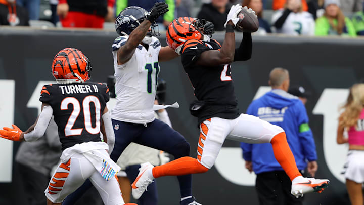 Cincinnati Bengals CB Mike Hilton intercepts the pass in front of Seattle Seahawks wide receiver Jaxon Smith-Njigba.