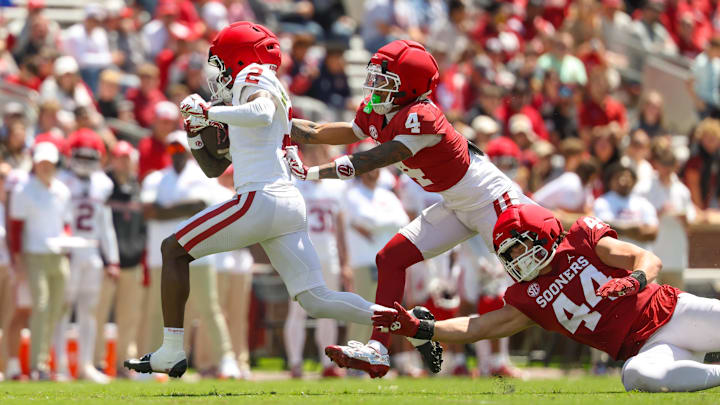 Oklahoma Sooners   wide receiver Jahsiear Rogers is chased by  defensive back Courtland Guillory and defensive lineman Taylor Wein during the Oklahoma Spring Game at Gaylord Family Memorial Stadium.