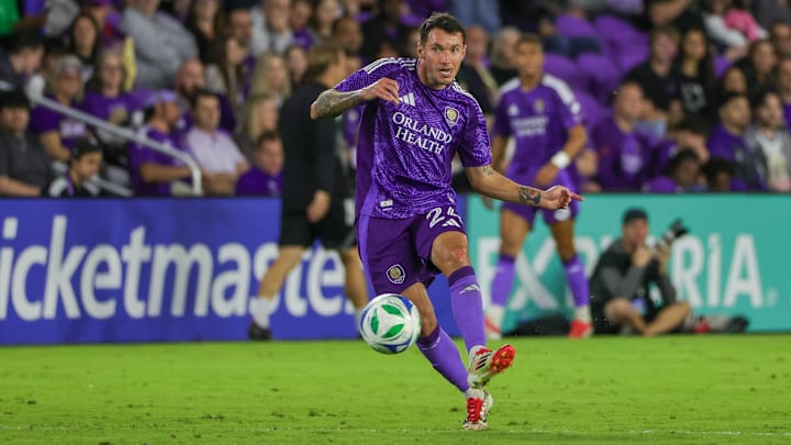 Mar 1, 2025; Orlando, Florida, USA; Orlando City defender Kyle Smith (24) kicks the ball during the second half against Toronto FC at Inter&Co Stadium. Mandatory Credit: Mike Watters-Imagn Images