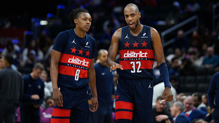 Mar 5, 2025; Washington, District of Columbia, USA; Washington Wizards forward Khris Middleton (32) and guard Bub Carrington (8) talk during the third quarter against the Utah Jazz at Capital One Arena. Mandatory Credit: Reggie Hildred-Imagn Images