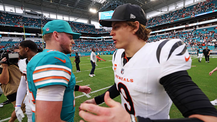 Dec 21, 2025; Miami Gardens, Florida, USA; Miami Dolphins quarterback Quinn Ewers (14) and Cincinnati Bengals quarterback Joe Burrow (9) react after the game at Hard Rock Stadium. Mandatory Credit: Nathan Ray Seebeck-Imagn Images