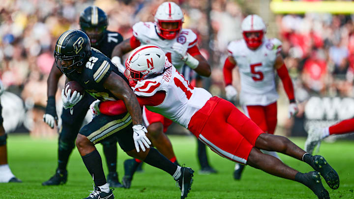 Sep 28, 2024; West Lafayette, Indiana, USA; Purdue Boilermakers running back Reggie Love III (23) is tackled by Nebraska Cornhuskers linebacker Princewill Umanmielen (18) during the second half at Ross-Ade Stadium. Mandatory Credit: Marc Lebryk-Imagn Images Sep 28, 2024; West Lafayette, Indiana, USA; Purdue Boilermakers running back Reggie Love III (23) is tackled by Nebraska Cornhuskers linebacker Princewill Umanmielen (18) during the second half at Ross-Ade Stadium. Mandatory Credit: Marc Lebryk-Imagn Images